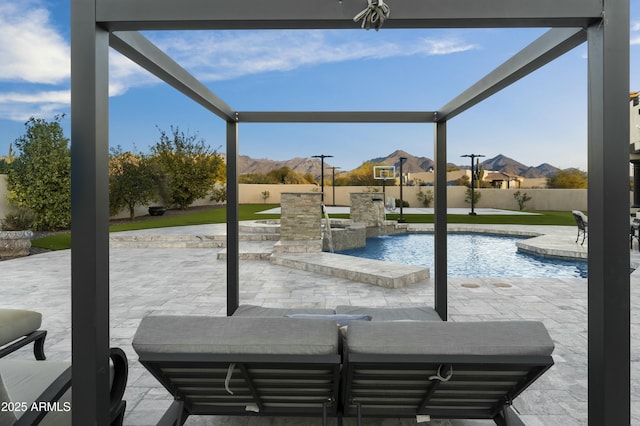 view of swimming pool featuring a mountain view and a patio