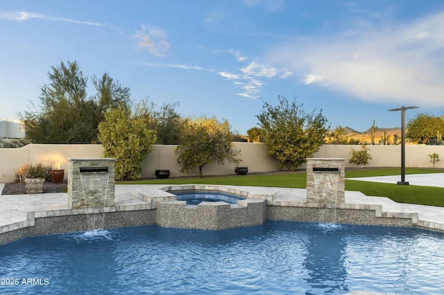 view of swimming pool featuring an in ground hot tub, a patio area, and pool water feature