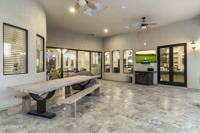 interior space with ceiling fan and a skylight