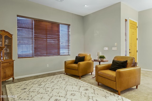 living area featuring carpet floors and baseboards