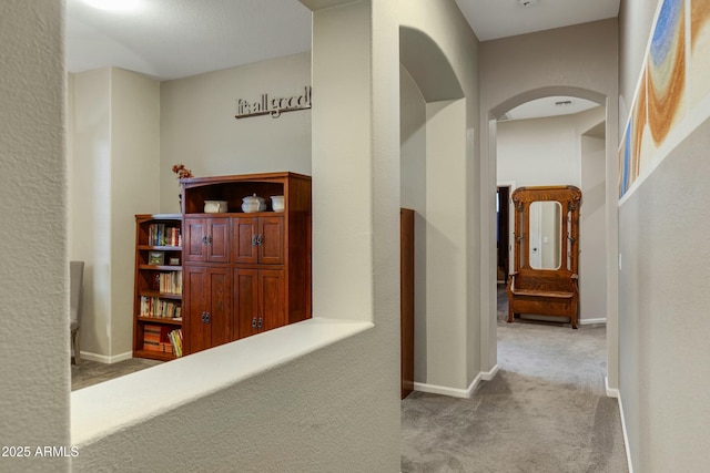 hallway with carpet and baseboards