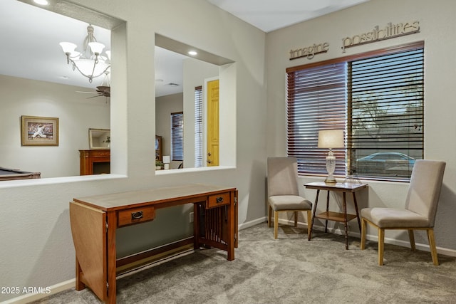 sitting room featuring ceiling fan with notable chandelier, carpet, and baseboards