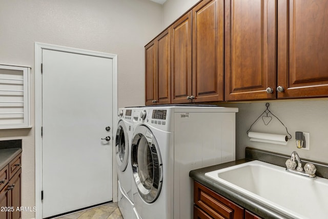 washroom with independent washer and dryer, cabinet space, and a sink