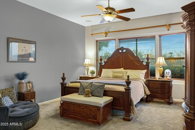 carpeted bedroom with ceiling fan and baseboards