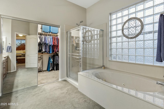 full bathroom featuring a spacious closet, a stall shower, and a jetted tub