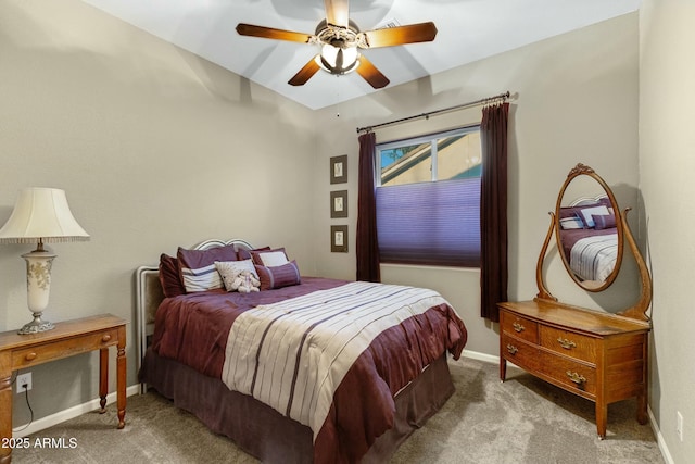 carpeted bedroom featuring baseboards and a ceiling fan