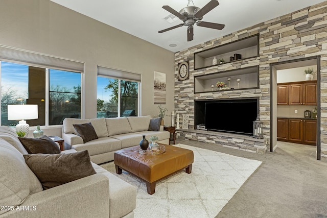 living room with visible vents, a ceiling fan, and light colored carpet