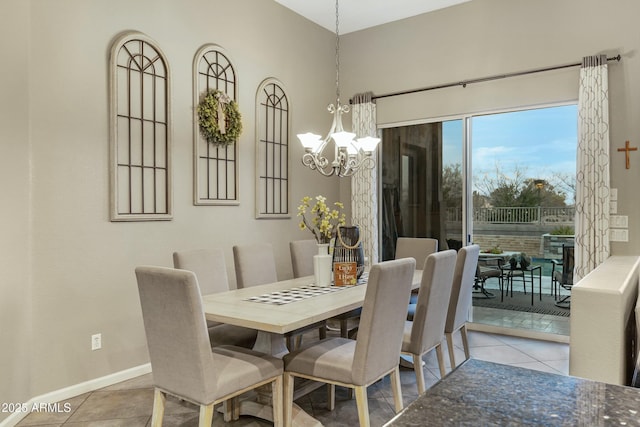 tiled dining space featuring a chandelier and baseboards