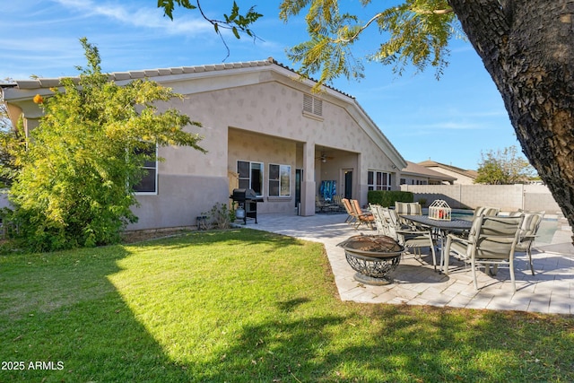 back of house featuring ceiling fan, fence, a yard, stucco siding, and a patio area