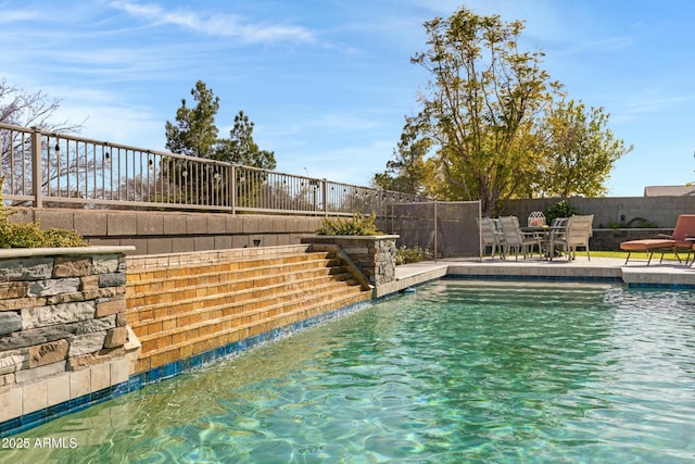 view of swimming pool with a fenced in pool, a fenced backyard, and a patio