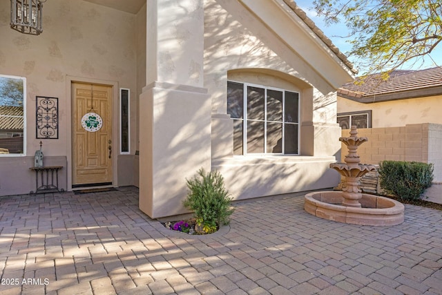 property entrance featuring stucco siding