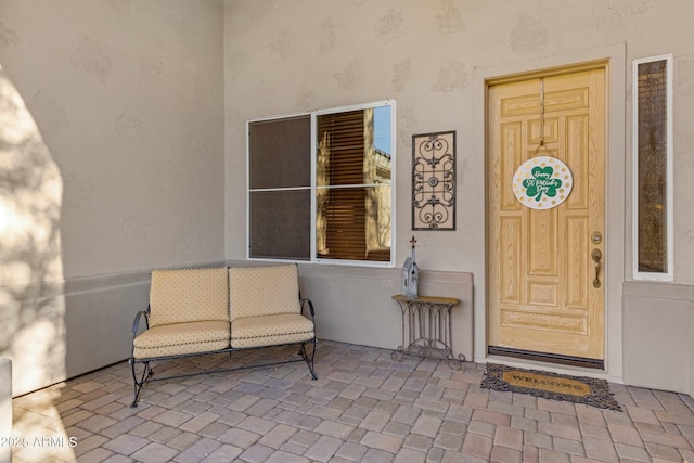 doorway to property featuring stucco siding