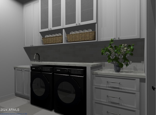 laundry room with cabinets and washing machine and clothes dryer