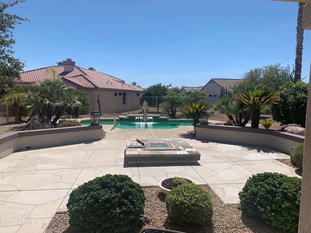 view of pool with pool water feature and a patio area