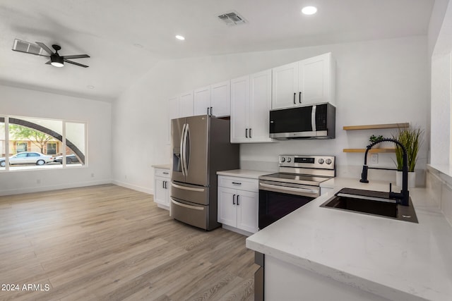 kitchen with sink, white cabinetry, vaulted ceiling, stainless steel appliances, and ceiling fan