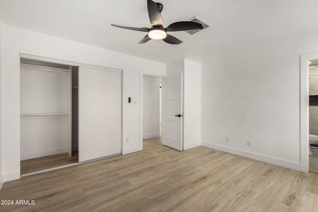 unfurnished bedroom featuring light hardwood / wood-style floors, ceiling fan, and a closet