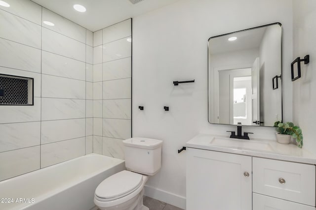 full bathroom featuring tile patterned floors, tiled shower / bath, vanity, and toilet