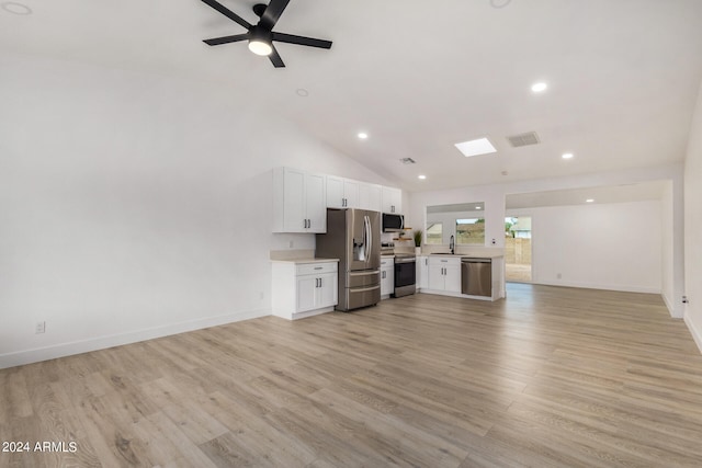 living room with light hardwood / wood-style flooring, ceiling fan, high vaulted ceiling, and sink