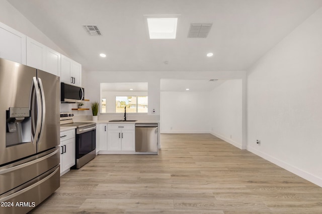 kitchen with white cabinets, light hardwood / wood-style floors, appliances with stainless steel finishes, and sink