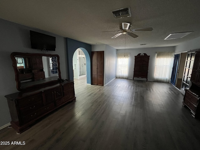 living room featuring ceiling fan, hardwood / wood-style floors, and a textured ceiling