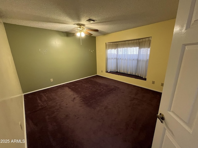 interior space with ceiling fan, carpet floors, and a textured ceiling