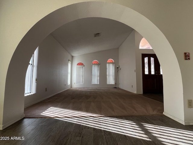 entryway with lofted ceiling and dark hardwood / wood-style floors