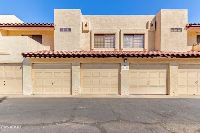 2020 W Union Hills Dr Unit 156, Phoenix, AZ 85027 - townhome / multi-family property featuring community garages, a tile roof, and stucco siding