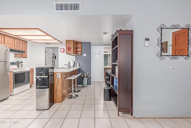 2020 W Union Hills Dr Unit 156, Phoenix, AZ 85027 - kitchen featuring electric range, freestanding refrigerator, open shelves, light tile patterned floors, and light countertops