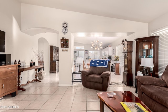 tiled living room featuring an inviting chandelier