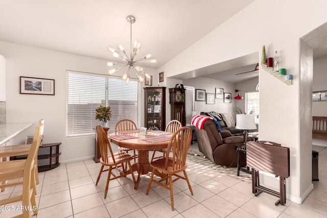 tiled dining space with an inviting chandelier and lofted ceiling