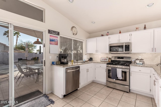 kitchen featuring stainless steel appliances, white cabinetry, sink, and decorative backsplash