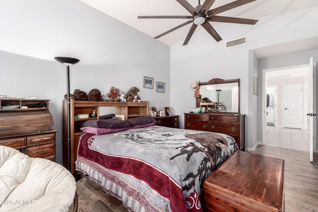 bedroom with light hardwood / wood-style flooring, ceiling fan, and vaulted ceiling