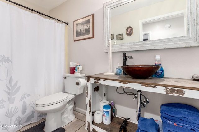 bathroom featuring tile patterned floors, toilet, and sink