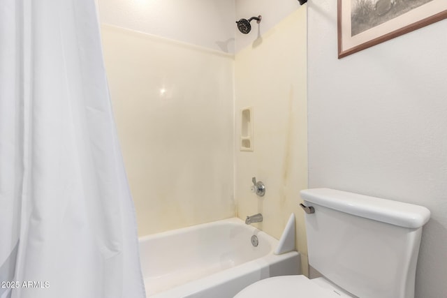 bathroom featuring shower / tub combo and toilet