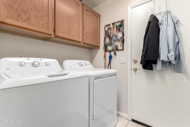 washroom with cabinets, independent washer and dryer, and light tile patterned flooring