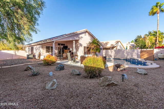 view of front facade with a patio and a fire pit