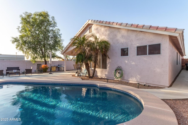 view of swimming pool with a patio area