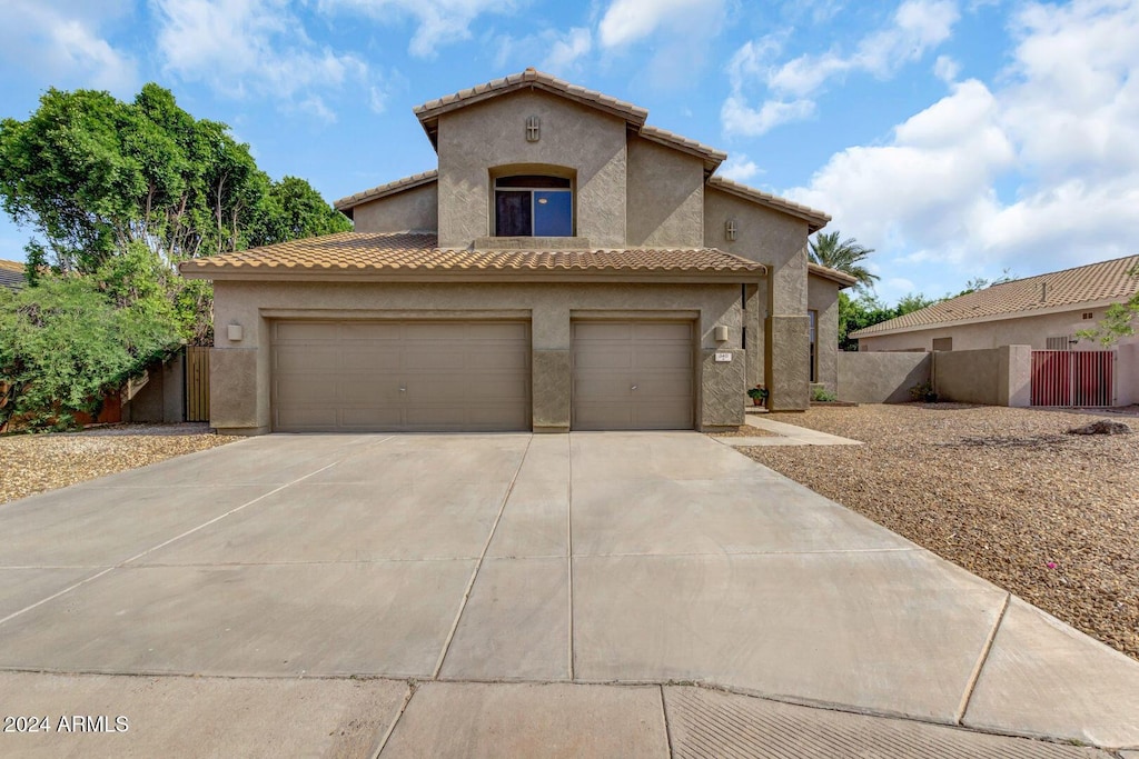 mediterranean / spanish-style house with a garage