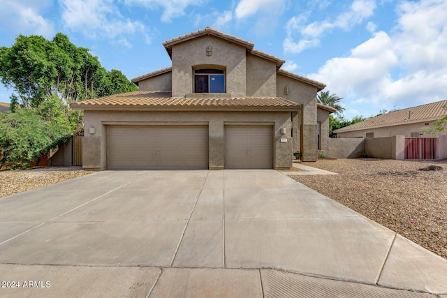 mediterranean / spanish-style house with a garage