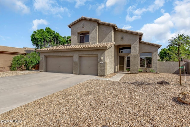 mediterranean / spanish-style home with a garage