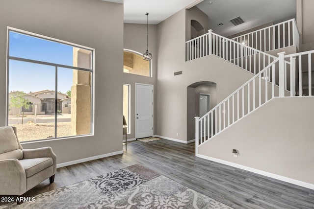 entryway with hardwood / wood-style floors and a high ceiling