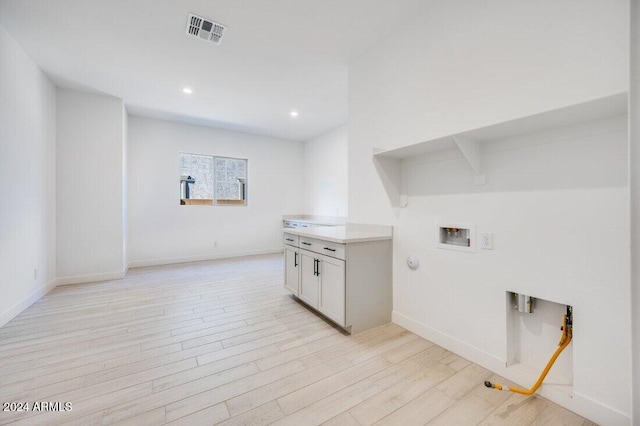 laundry room featuring washer hookup, light hardwood / wood-style floors, and gas dryer hookup