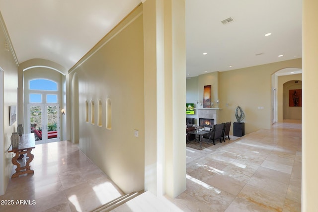 hallway with french doors and vaulted ceiling