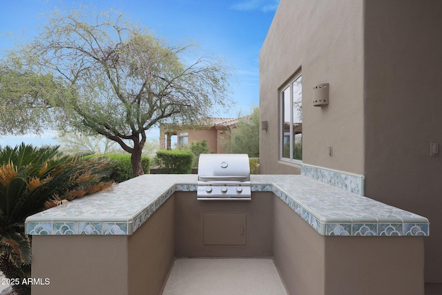 view of patio / terrace with area for grilling and a grill