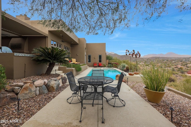 view of pool featuring a mountain view and a patio