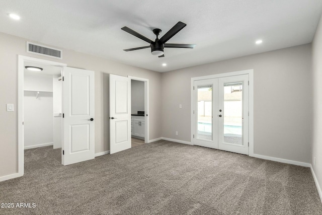 unfurnished bedroom featuring visible vents, baseboards, access to exterior, carpet, and french doors