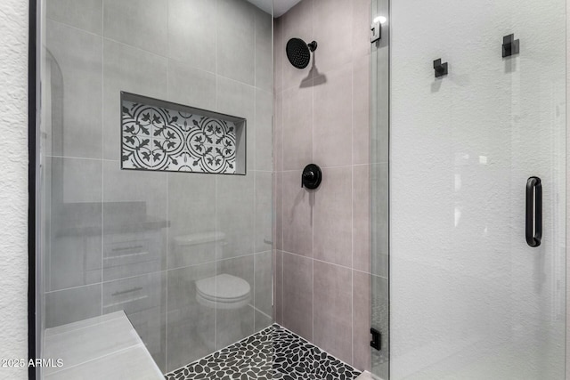 full bathroom with a shower stall and toilet