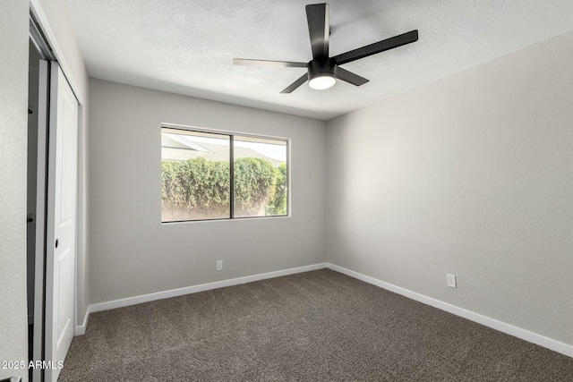 unfurnished bedroom with a closet, carpet flooring, a textured ceiling, and baseboards