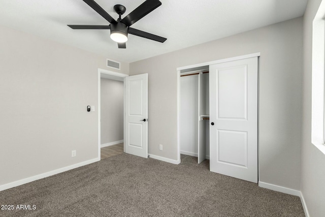 unfurnished bedroom featuring carpet floors, a closet, visible vents, and baseboards