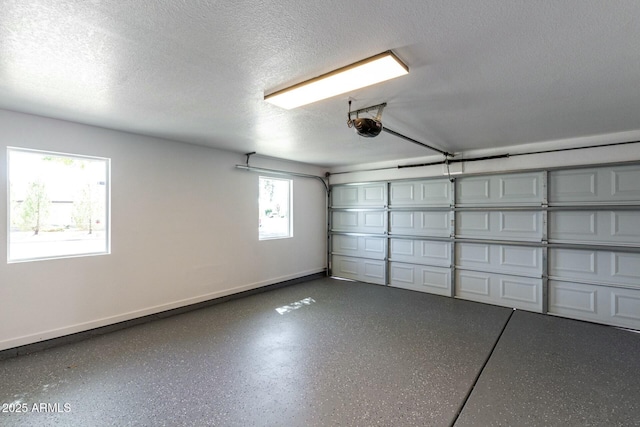 garage with a garage door opener and baseboards